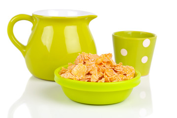 bowl of cornflakes with a jug of milk, on white background