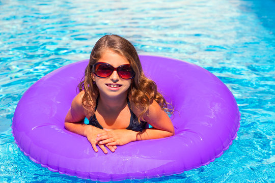 bikini girl with sunglasses and inflatable pool ring