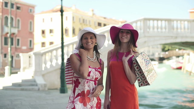Portrait of smiling female friends with shopping bags, Venice 