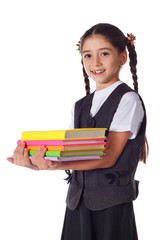 Smiling girl standing with stack of books