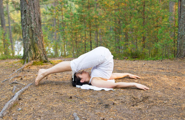 Young woman in yoga plough pose