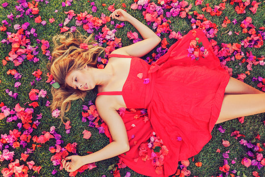 Beautiful Young Woman Lying in Flowers