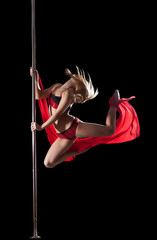 Woman jump during pole dance with fabric