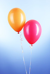 Two colorful balloons on blue background