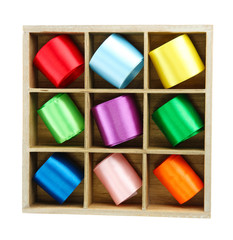 bright silk ribbons  in wooden box, isolated on white