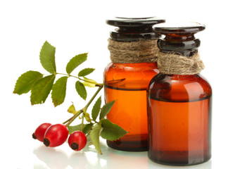 medicine bottles with hip roses, isolated on white