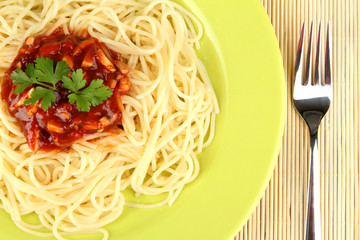 Italian spaghetti in plate on bamboo mat