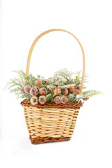 bouquet in wooden basket over white