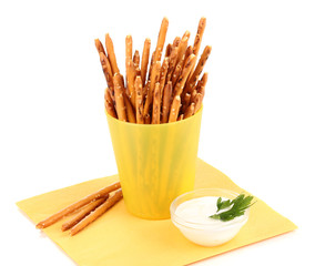 Tasty crispy sticks in yellow plastic cup isolated on white