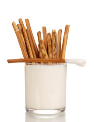 Tasty crispy sticks in glass with sour cream isolated on white