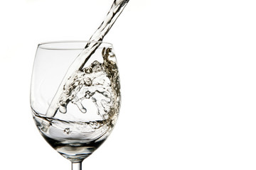 Pouring wine into glass isolated on white