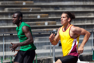 Two Track and Field Athletes Running