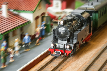express steam train speeding through a station