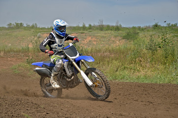 MX rider on a motorcycle in a bend