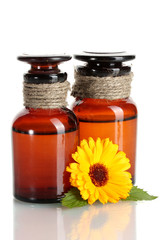 medicine bottles and beautiful calendula flowers, isolated