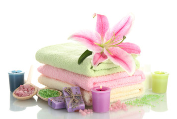 Obraz na płótnie Canvas towels with lily, aroma oil, candles, soap and sea salt