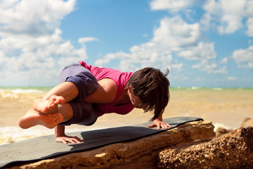 Woman doing eight arcs twist yoga pose