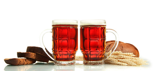 tankards of kvass and rye breads with ears, isolated on white