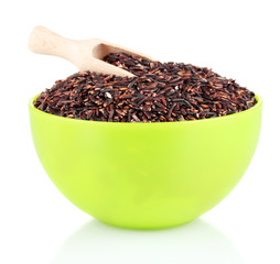 brown rice in a yellow  plate with a wooden scoop  , isolated