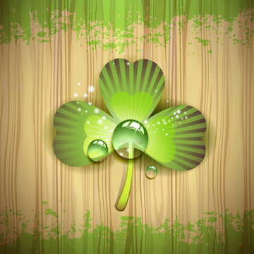 Wood background with clover and drops of water