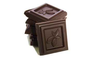 chocolate pieces tower isolated on a white embossed cocoa beans