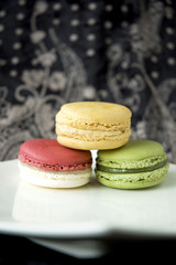 three color macarons on black