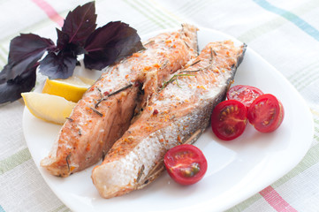 salmon steak with cherry tomatoes basil and lemon
