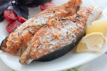 salmon steak with cherry tomatoes basil and lemon