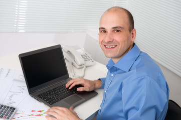 relaxed young business man with laptop