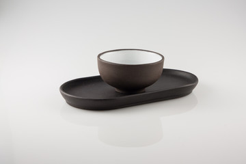 cup and saucer for green tea on a white