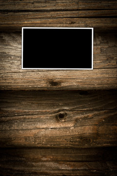 Empty photo frame on a dark wooden background