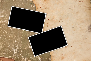 Empty photo frames on a vintage paper background