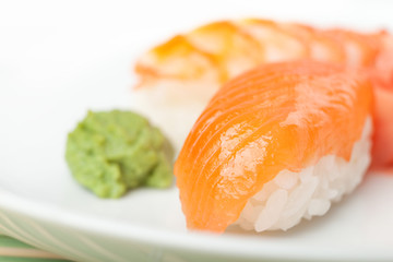 Close up of nigiri sushi on the plate with wasabi sauce