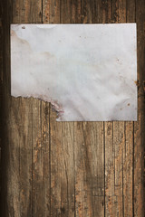 Torn paper sheet on a wooden background