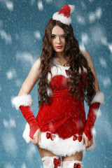 Beautiful  girl wearing santa claus clothes with christmas gift 