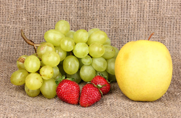 ripe sweet fruits and berries on sackcloth