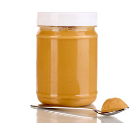 Delicious peanut butter in jar isolated on white
