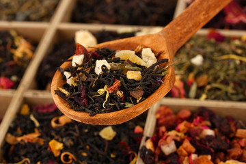 assortment of dry tea in wooden box, close up