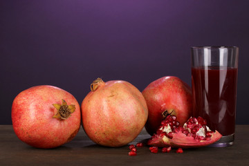 Ripe pomegranates with glass of pomegranate juice
