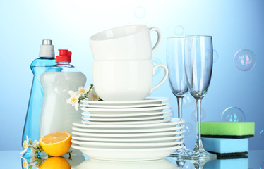 empty clean plates, glasses and cups with dishwashing liquid,