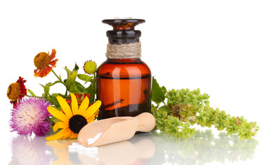 medicine bottle with tablets and flowers isolated on white