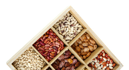 Diverse beans in wooden box sections isolated on white