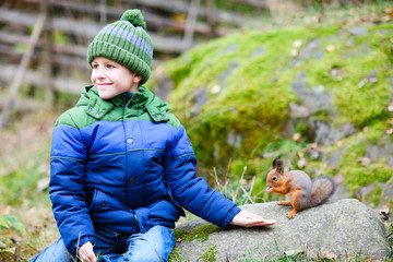 Cute boy and squirrel © TravelPhotoBloggers