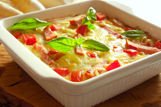 casserole with cheese, bacon and tomatoes