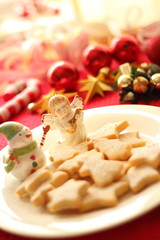 Christmas ornaments and homemade cookies on red table