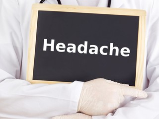 Doctor shows information on blackboard: headache