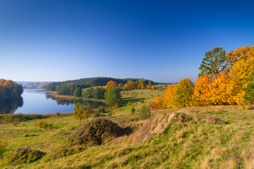 Autumnal scenery of meadow and lake in Poland
