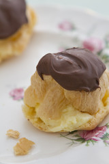 Profiterole eclair on vintage plate