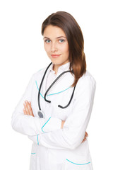Portrait of young female doctor with arms crossed isolated