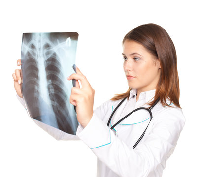 Young female doctor looking at the x-ray picture of lungs isolat
